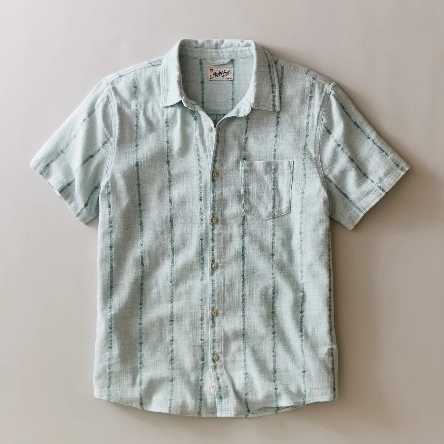Marine Layer Men's Blue Embroidery Stretch Selvage Short Sleeve Shirt, available at Harbour Thread men's store in Burlington, VT