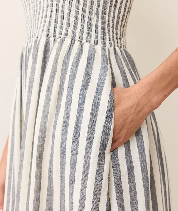 The Marine Layer Sutton Strapless Maxi Dress features a comfortable smocked bodice and convenient side pockets