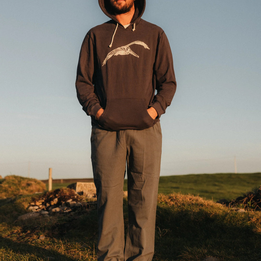 
                      
                        Front view of man wearing a faded navy hooded pullover with a pelican graphic on the front
                      
                    