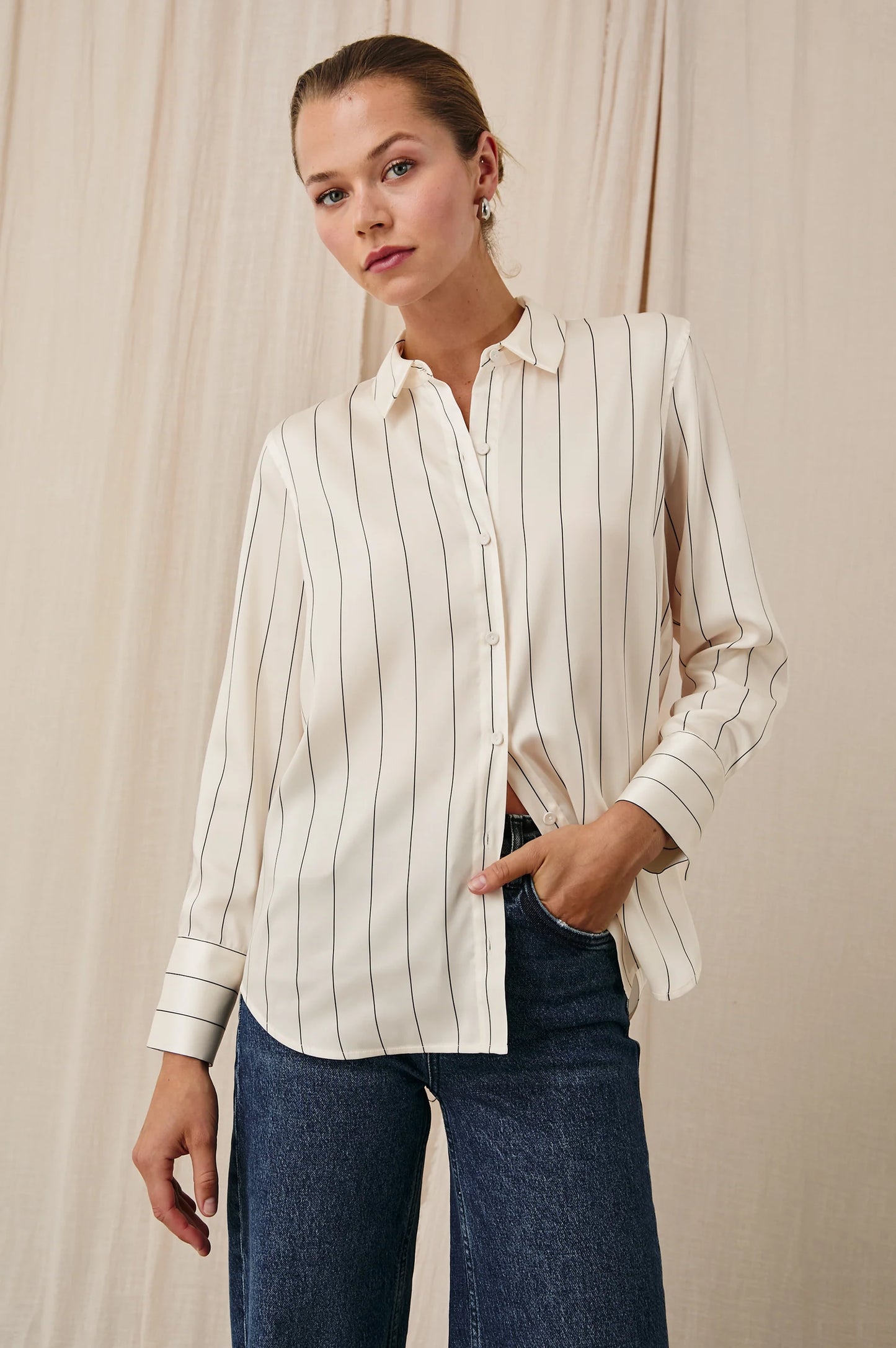 A woman wearing the Brixton Stripe Saige Shirt by the brand Rails