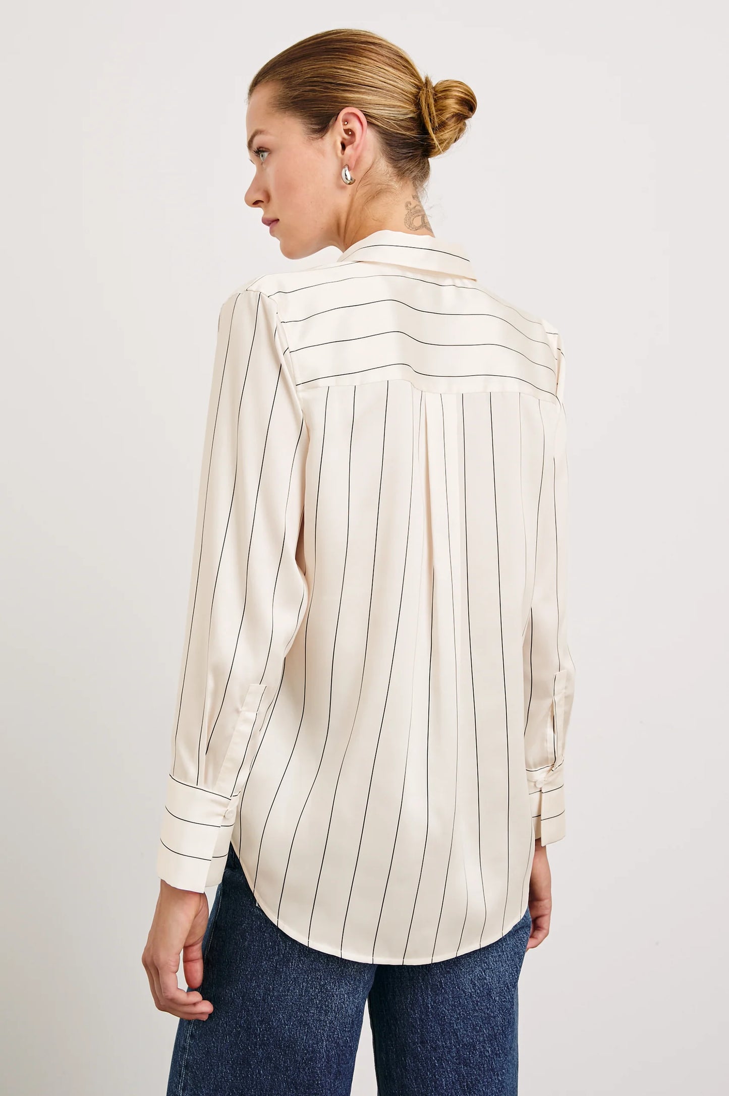 Back view of a woman wearing the Brixton Stripe Saige Shirt by the brand Rails