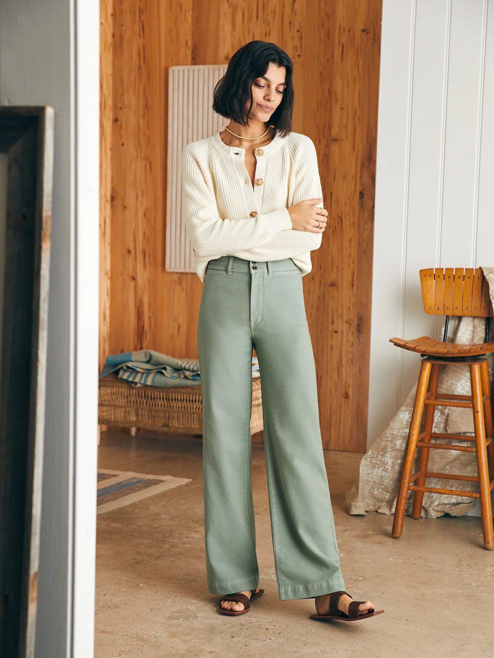 Front view of woman wearing sage color stretch terry pocket pants by Faherty