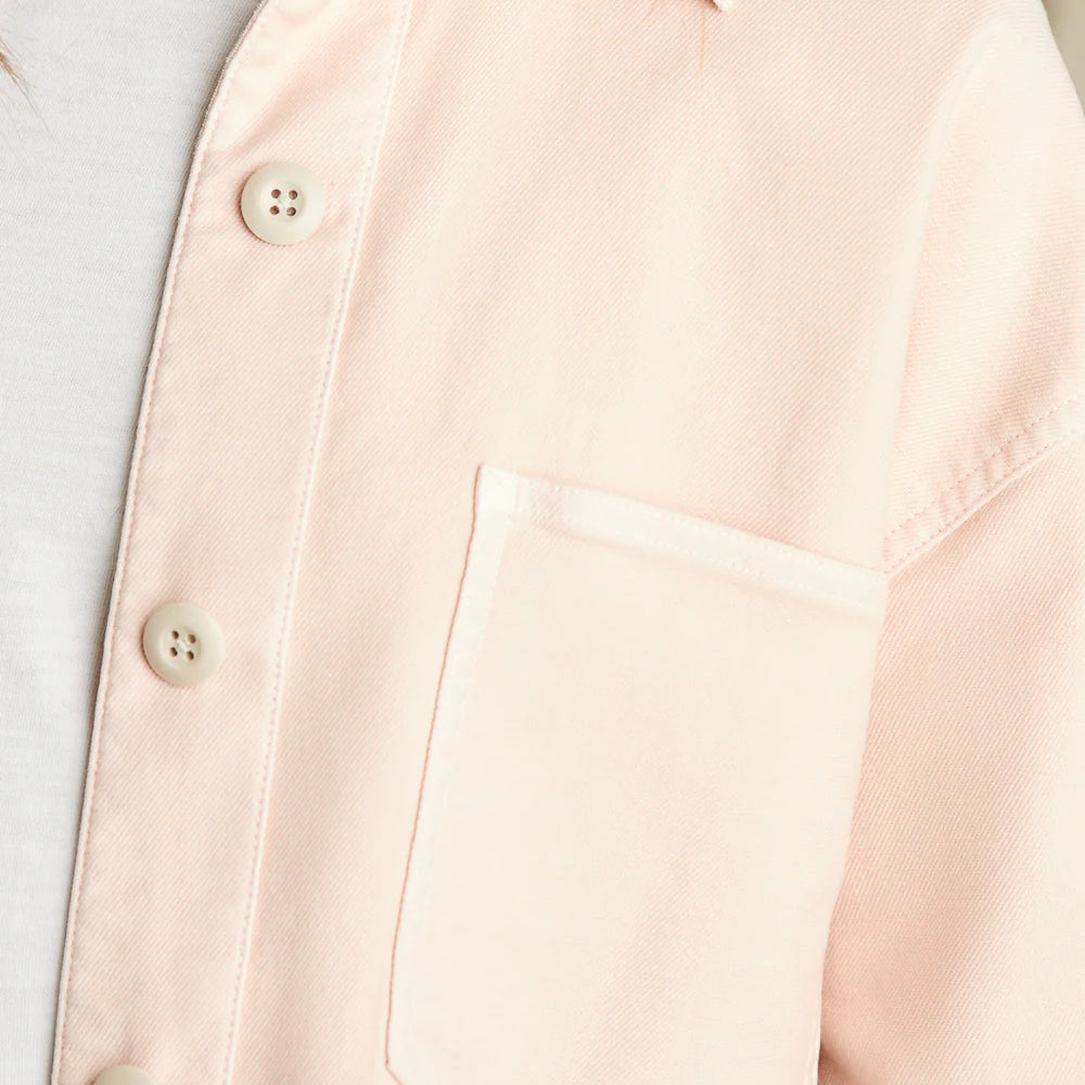 
                      
                        Close up view of the buttons and front pocket detail on the peach color Stretch Terry Overshirt by Faherty
                      
                    