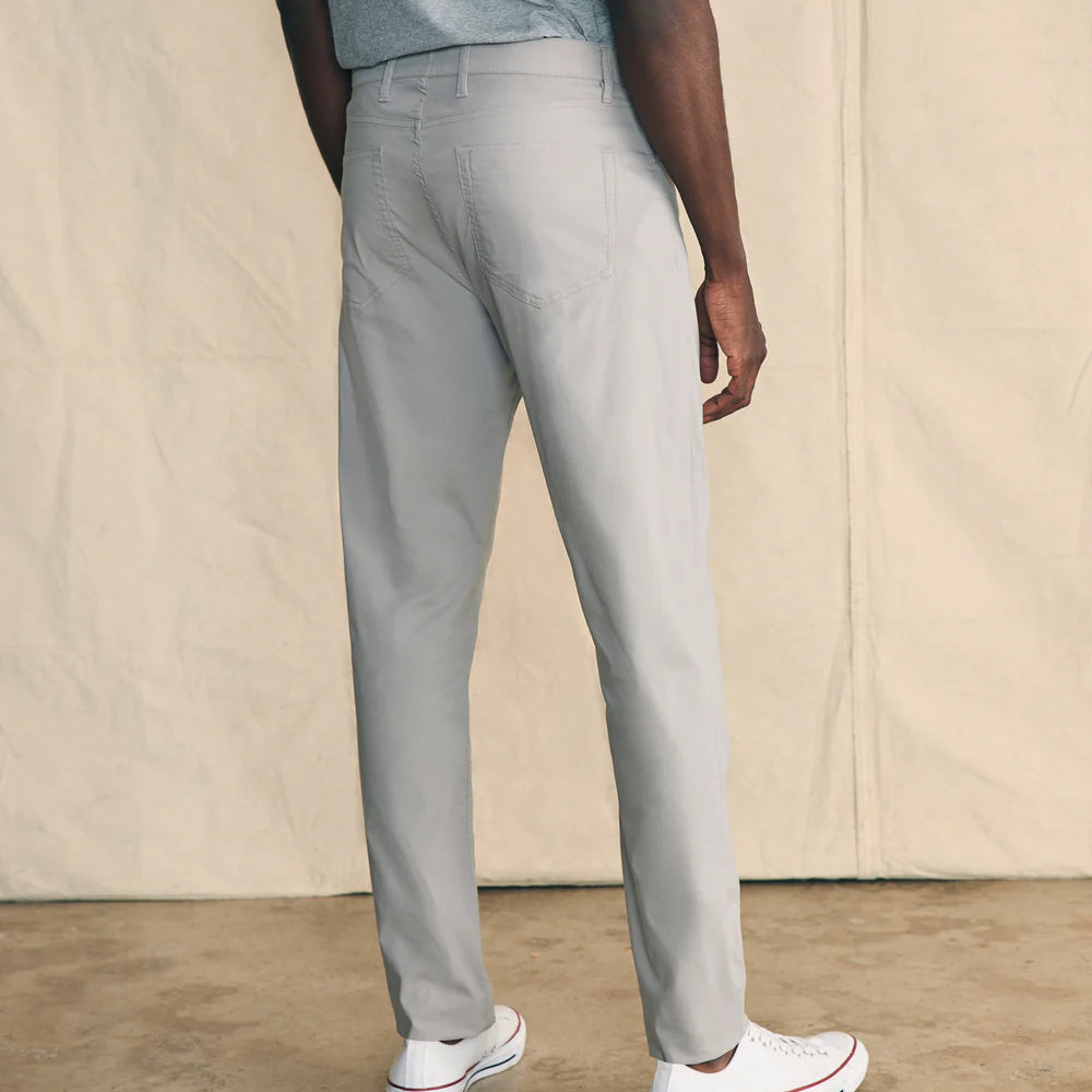 Back view of the men's Movement 5-Pocket Pant by Faherty, in the color Fossil