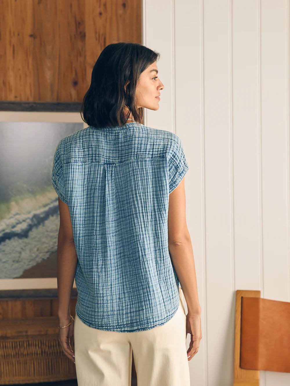 Back view, untucked styling for the Faherty Dream Cotton Gauze Desmond Top in the color Light Indigo Wash