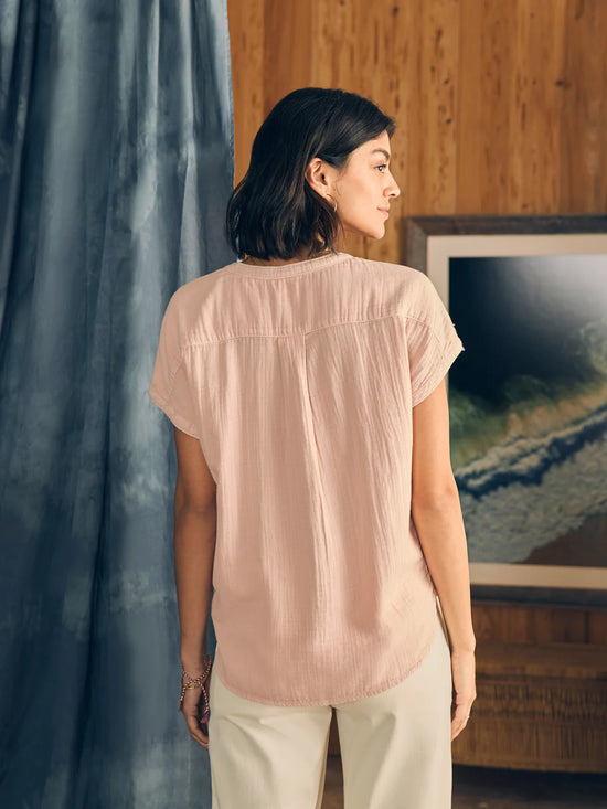Back view, untucked styling for the Faherty Dream Cotton Gauze Desmond Top in the color Peach Whip
