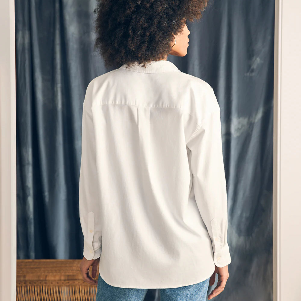 
                      
                        Back view of a woman wearing Faherty's Stretch Oxford Relaxed Shirt in the color White
                      
                    