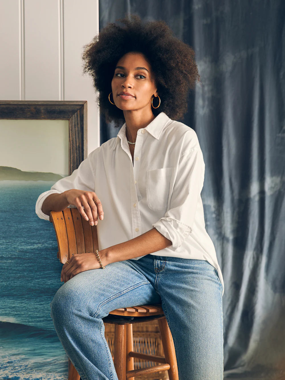 Women's wearing Faherty's Stretch Oxford Relaxed Shirt in the color White