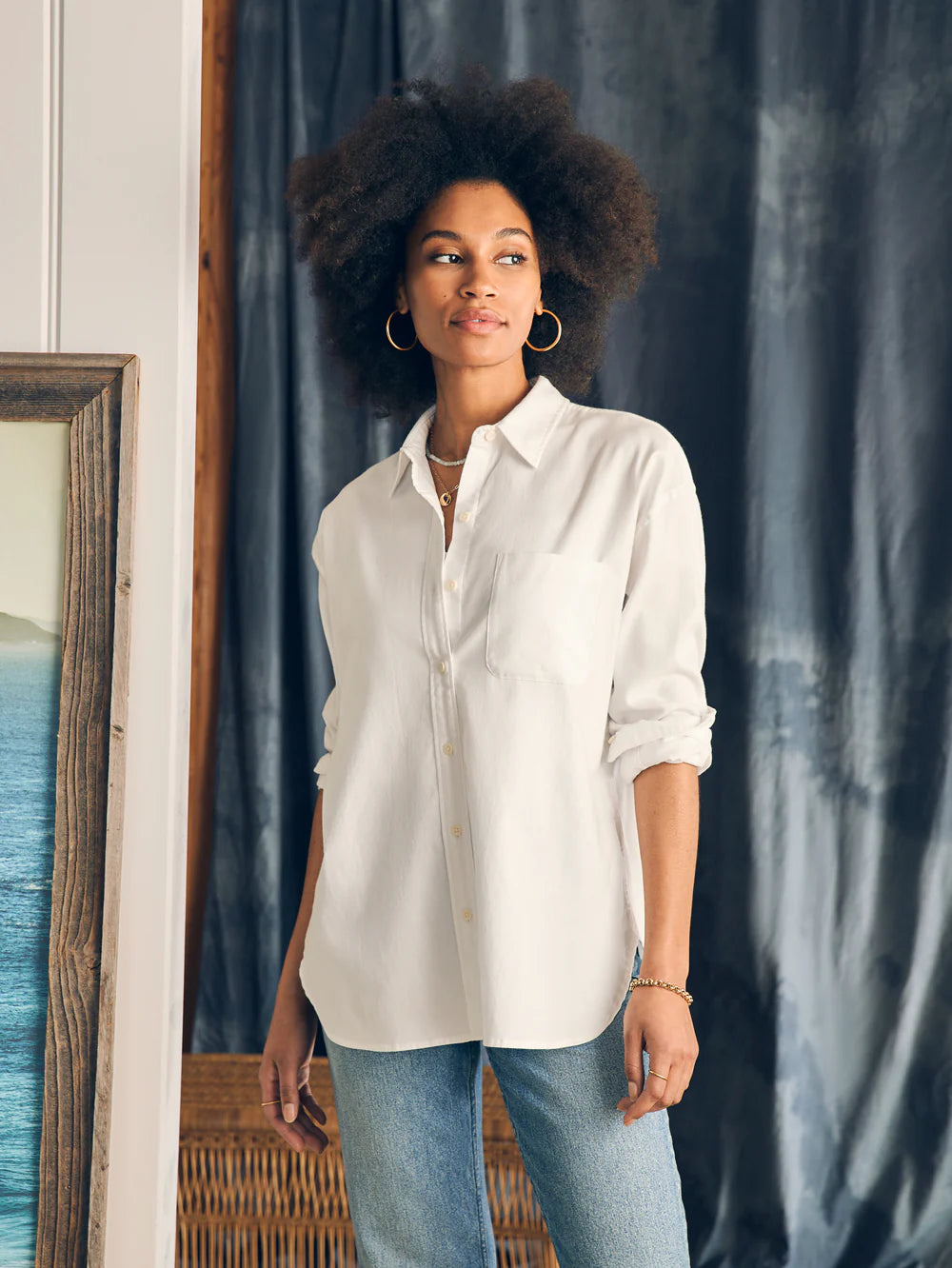 Front view of a woman wearing Faherty's Stretch Oxford Relaxed Shirt in the color White