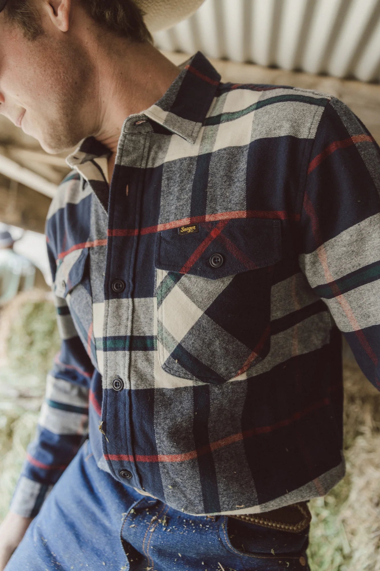 A man wearing the Calico Flannel Big Plaid Shirt by the brand Seager