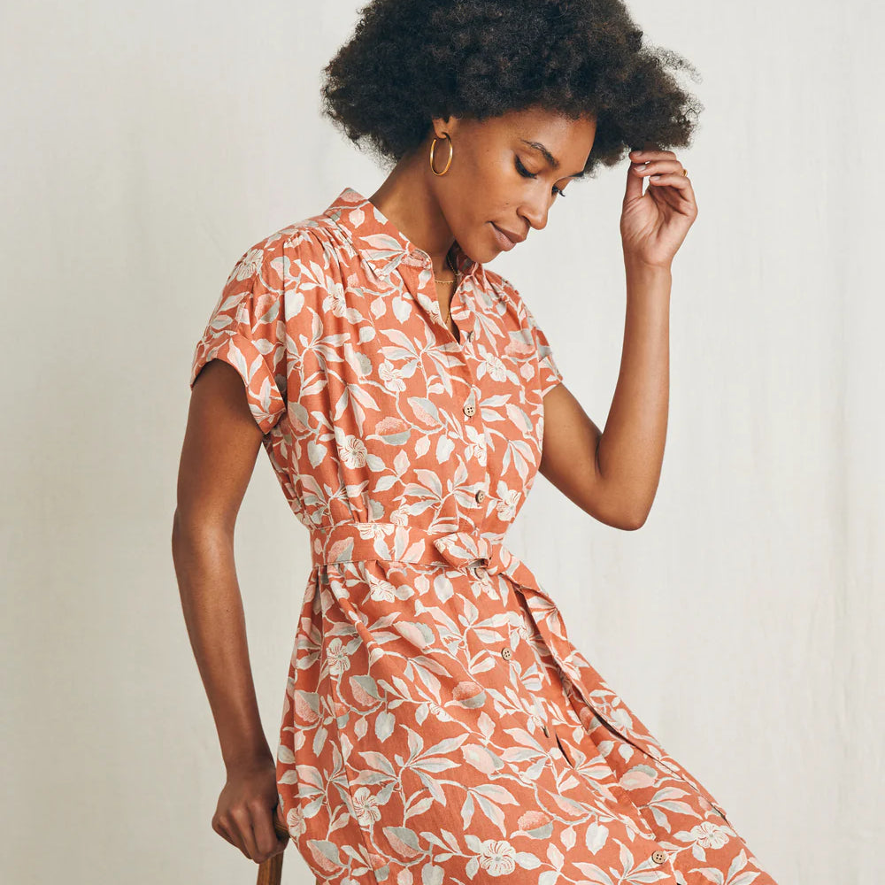 
                      
                        Woman sitting while wearing the Ginger Floral Breeze Shirtdress by Faherty
                      
                    