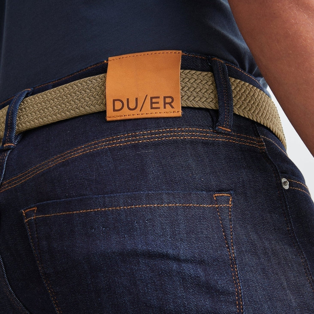 Back view of man wearing the sand color Performance Stretch Belt by DU/ER