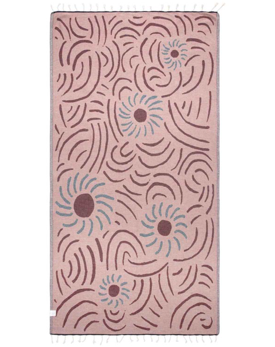 unfolded reverse color view of a beach towel featuring artful flower and line designs and tassels at the end