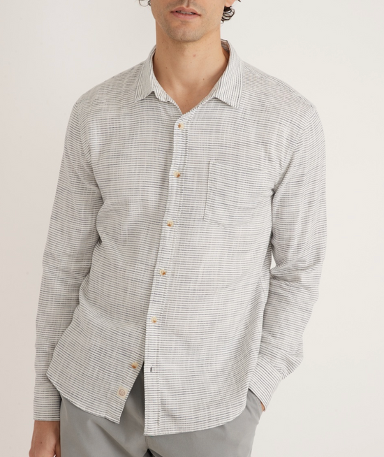Front view of men's long sleeve classic stretch selvage button up shirt in color natural/black stripe by Marine Layer