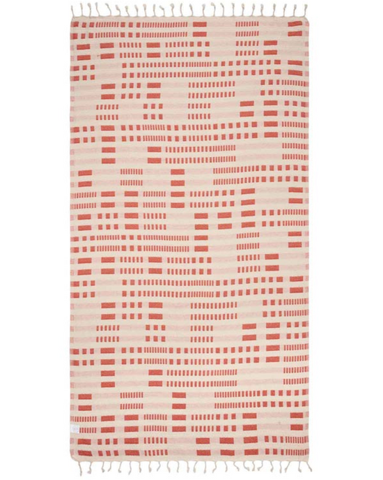 Reverse Unfolded view of the Canggu Beach Towel by Sand Cloud featuring a line and dash design throughout and tassels at the ends