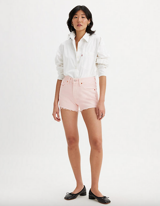 Front view of woman wearing pink denim cutoff shorts