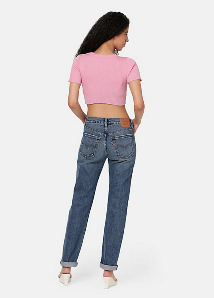 
                      
                        Back view of a woman wearing the medium wash straight leg women's jeans by Levi's
                      
                    