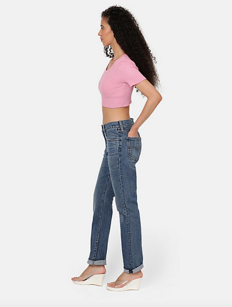 
                      
                        Side view of a woman wearing the medium wash straight leg women's jeans by Levi's
                      
                    