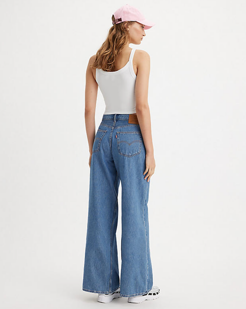 
                      
                        Back view of a woman wearing the medium wash Baggy Dad Wide Leg Jeans by Levi's
                      
                    