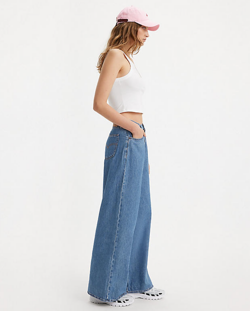 
                      
                        Side view of a woman wearing the medium wash Baggy Dad Wide Leg Jeans by Levi's
                      
                    