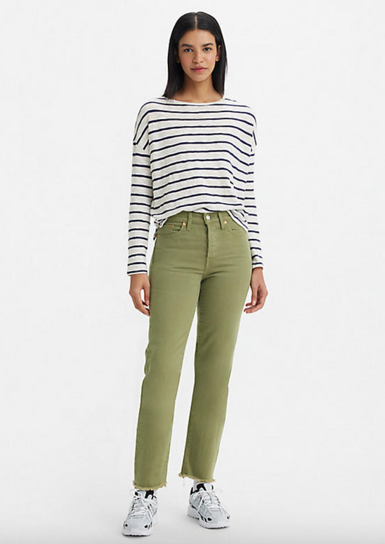 Front view of a woman wearing green high rise straight leg jeans by Levi's