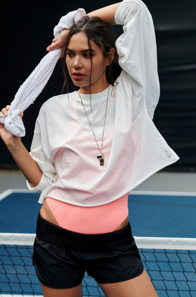 
                      
                        Woman on a court wearing the Inspire Layer Top by Free People
                      
                    