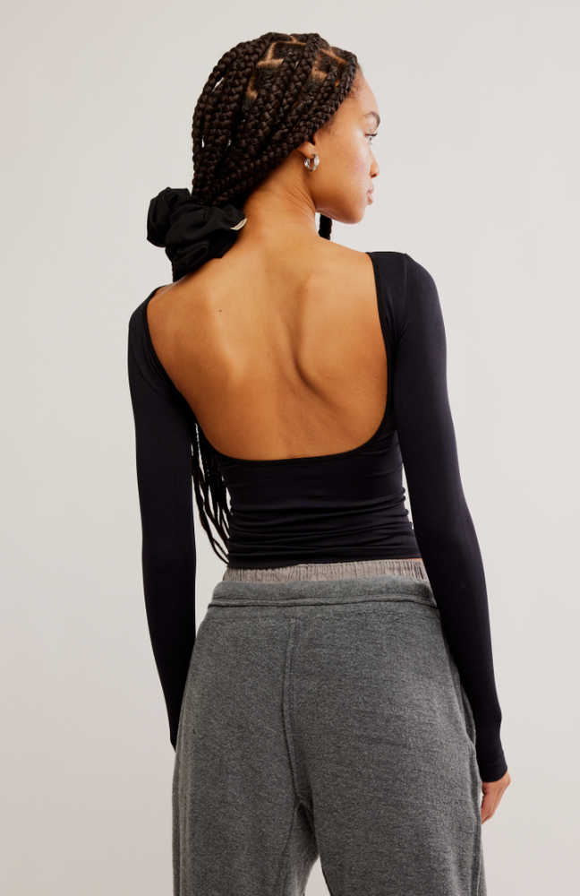 Back view of the Black Low Back Seamless Long Sleeve Top by Free People