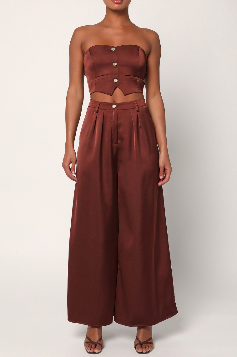 An outfit styled with the Pur-Suit Of Perfection Brown Satin Cropped Strapless Vest Top and brown satin wide leg pants by Lulus