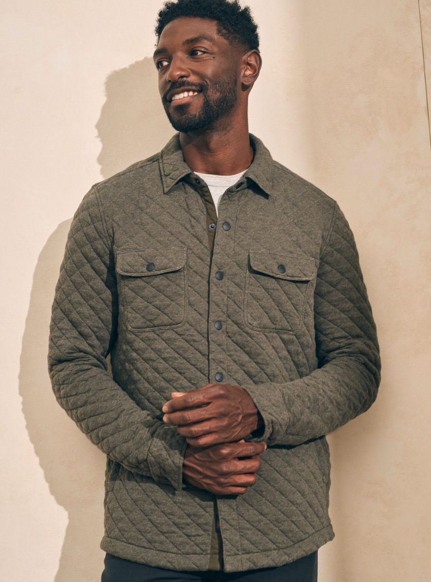 A man wearing the Olive Melange  Epic Quilted Fleece CPO by the brand Faherty