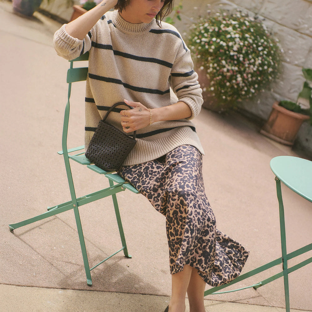 
                      
                        A woman wearing the Avery Midi Skirt in Leopard from Marine Layer. 
                      
                    
