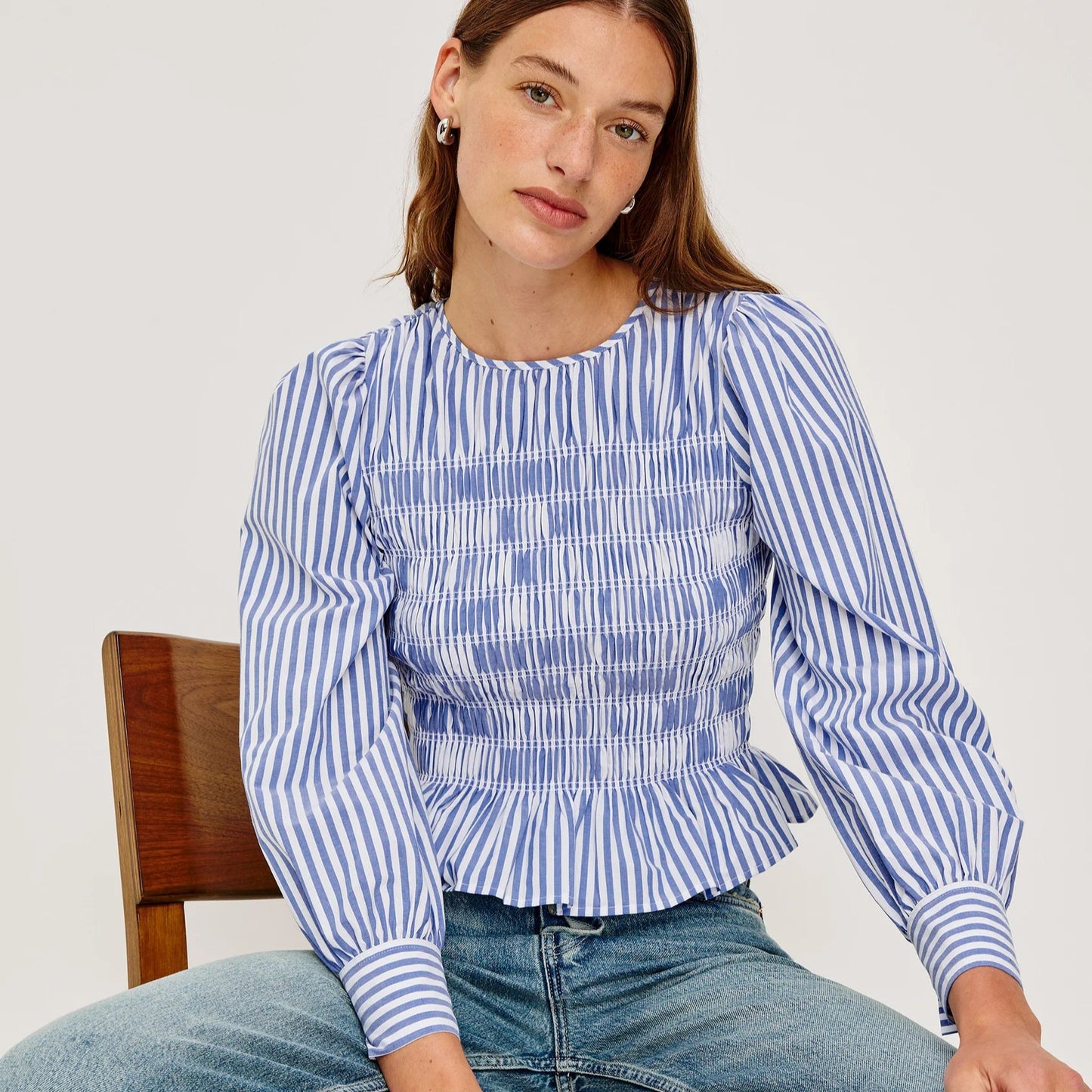 A woman wearing the blue and white striped Tabi Top from Rails