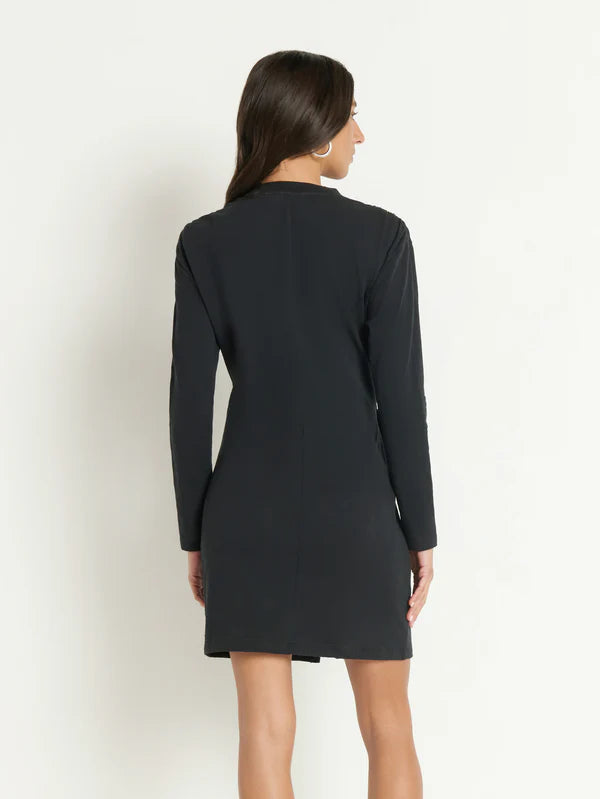 Woman wearing a long sleeve black mini dress