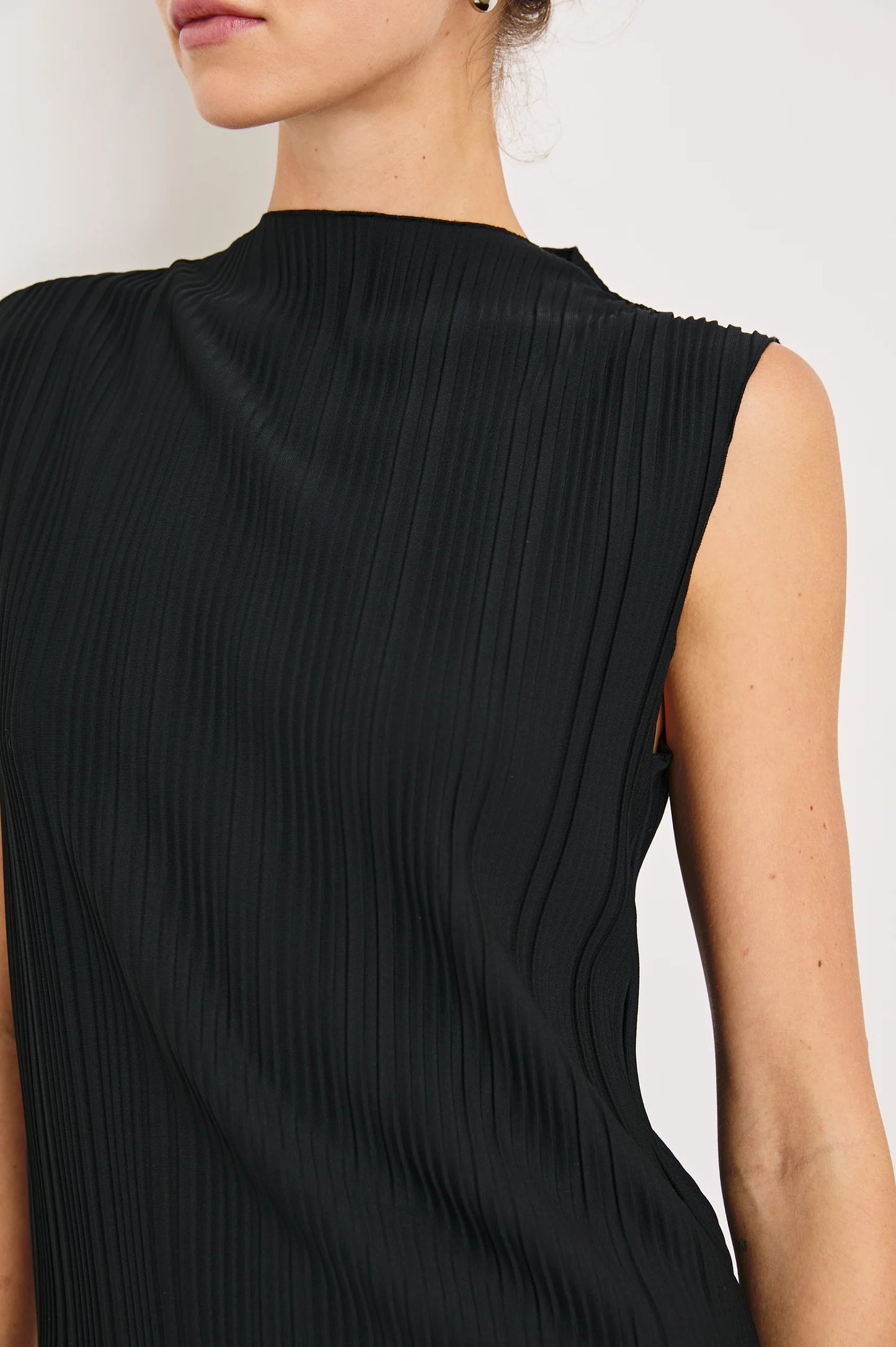 The Trea is a women's sleeveless mock-neck top