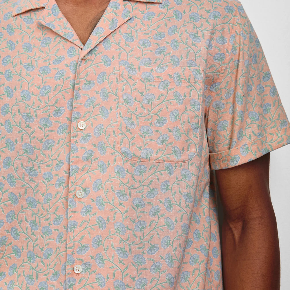 
                      
                        Men's pink short sleeve button down shirt with blue floral print
                      
                    