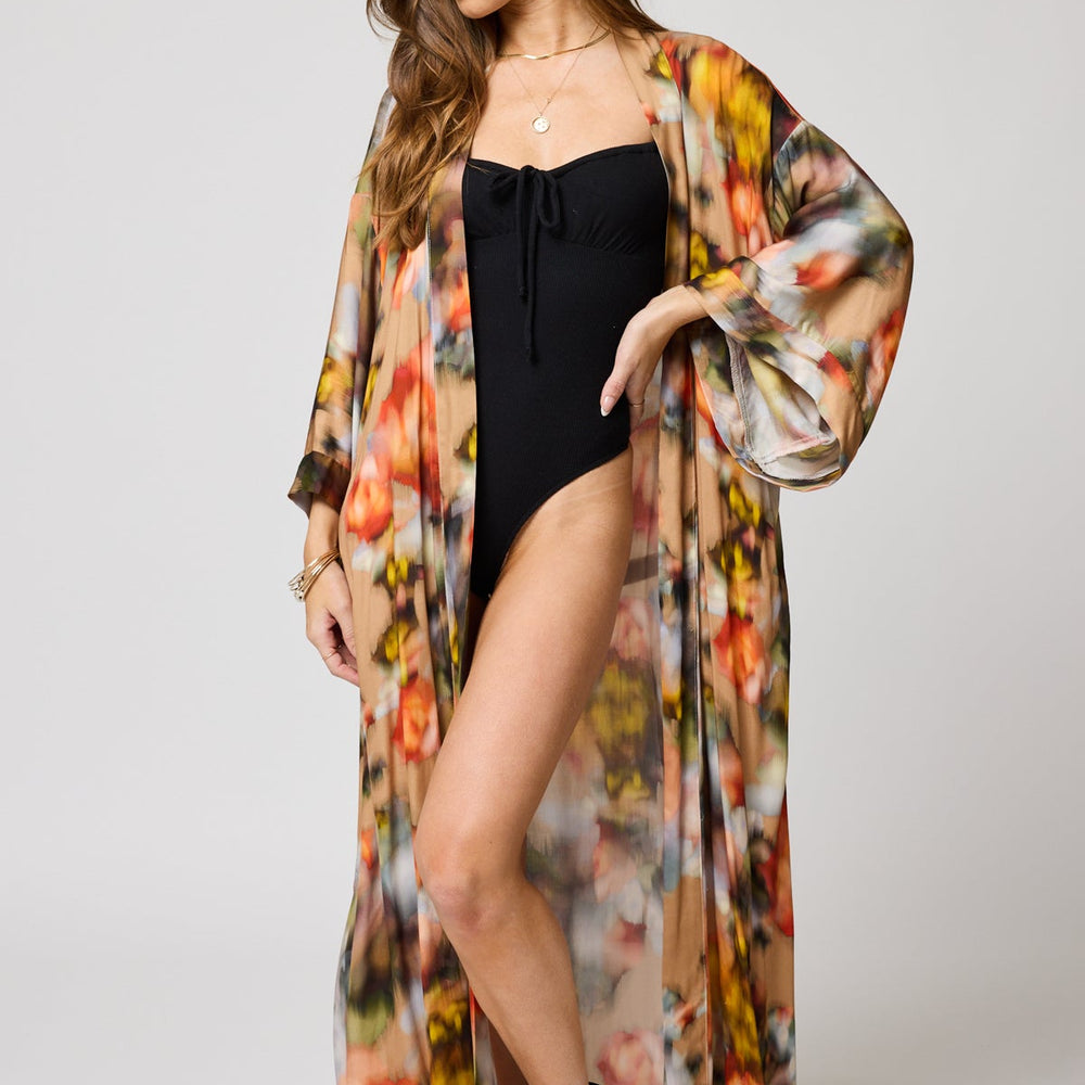 A woman wearing the Watercolor Floral Morning Robe by Stillwater