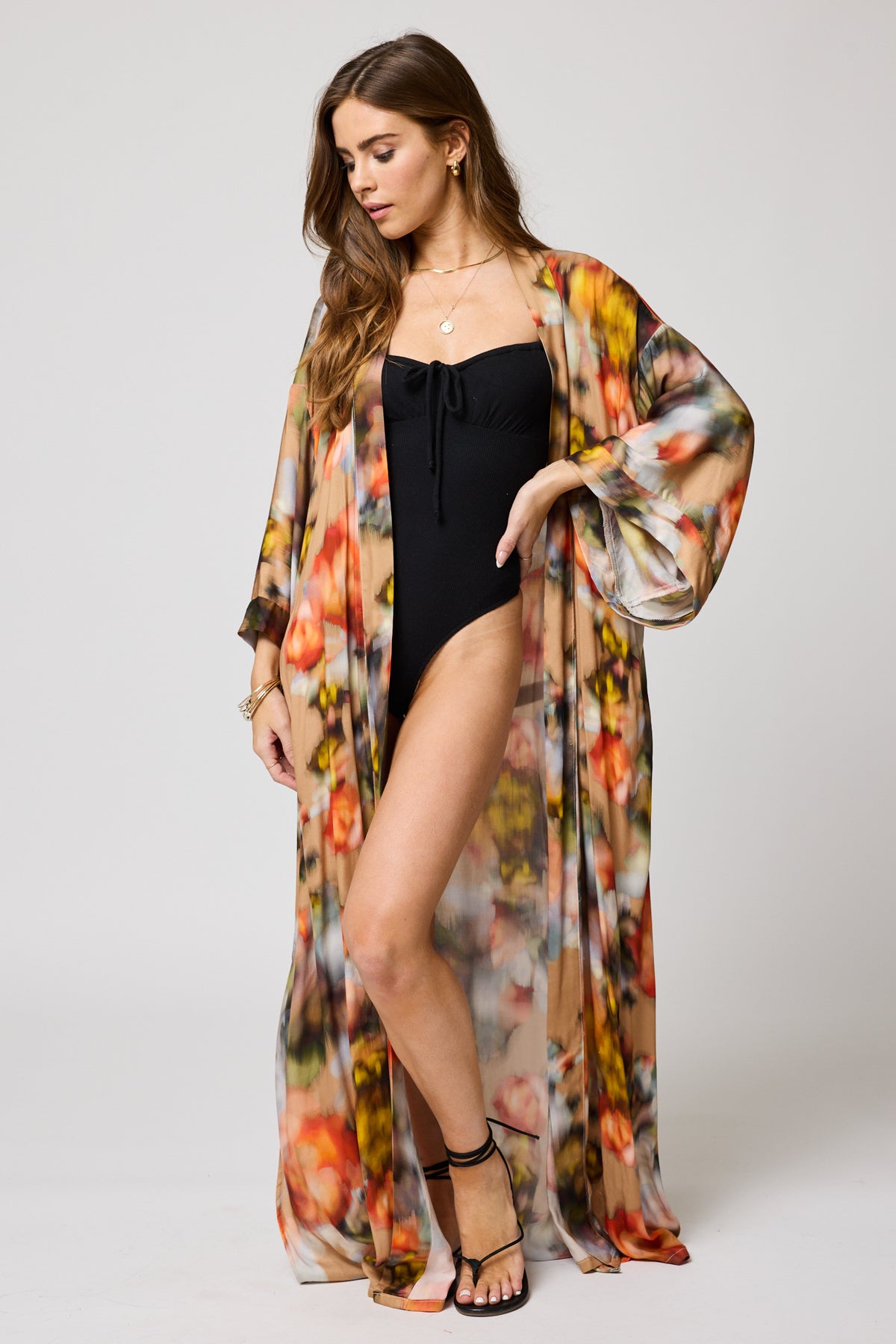 A woman wearing the Watercolor Floral Morning Robe by Stillwater