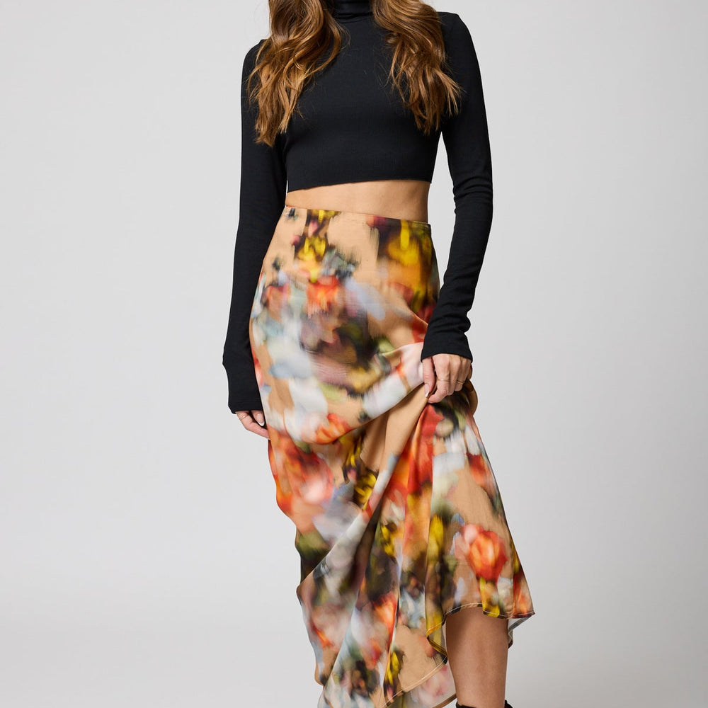 Front view of a woman wearing the Watercolor Floral Good Grace maxi Skirt by Stillwater