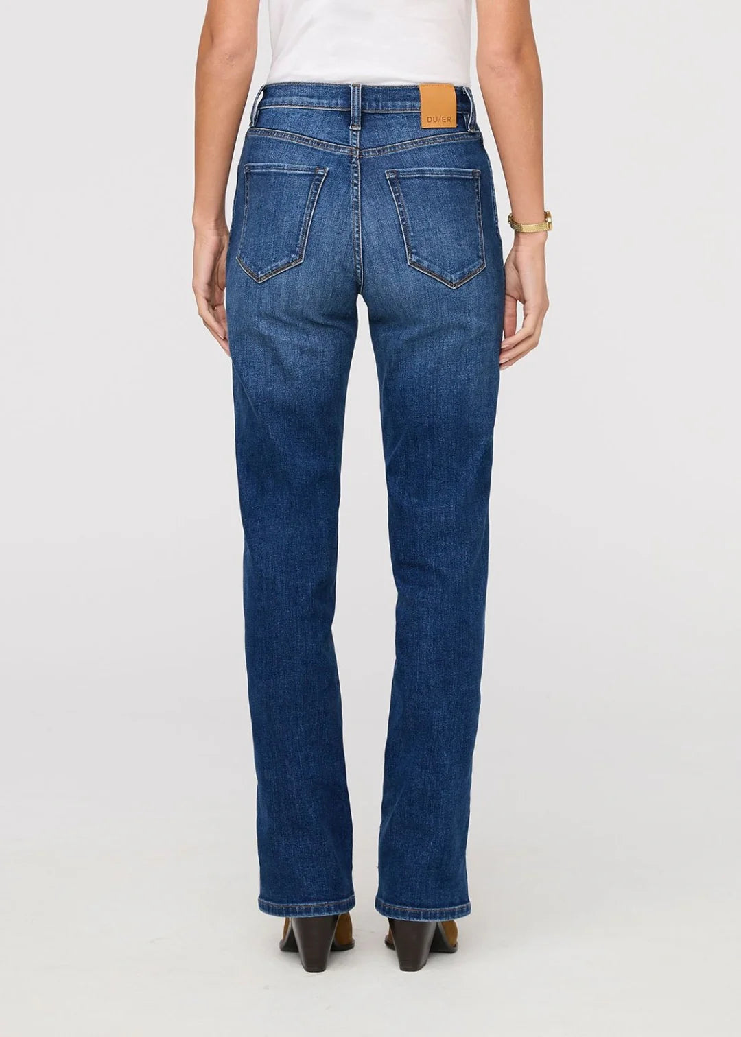 Person wearing blue jeans on a white background