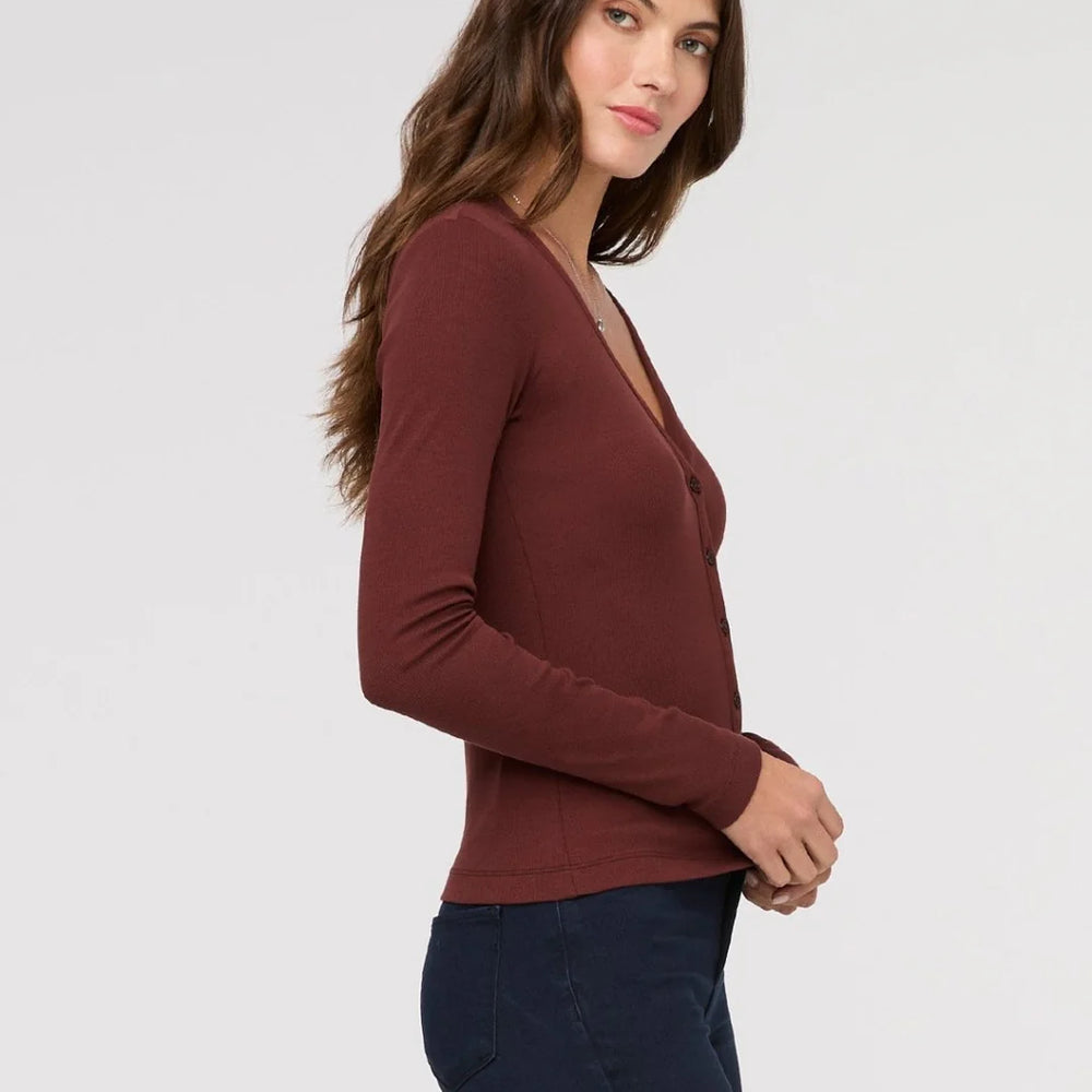 Woman wearing a maroon long-sleeve top from DUER