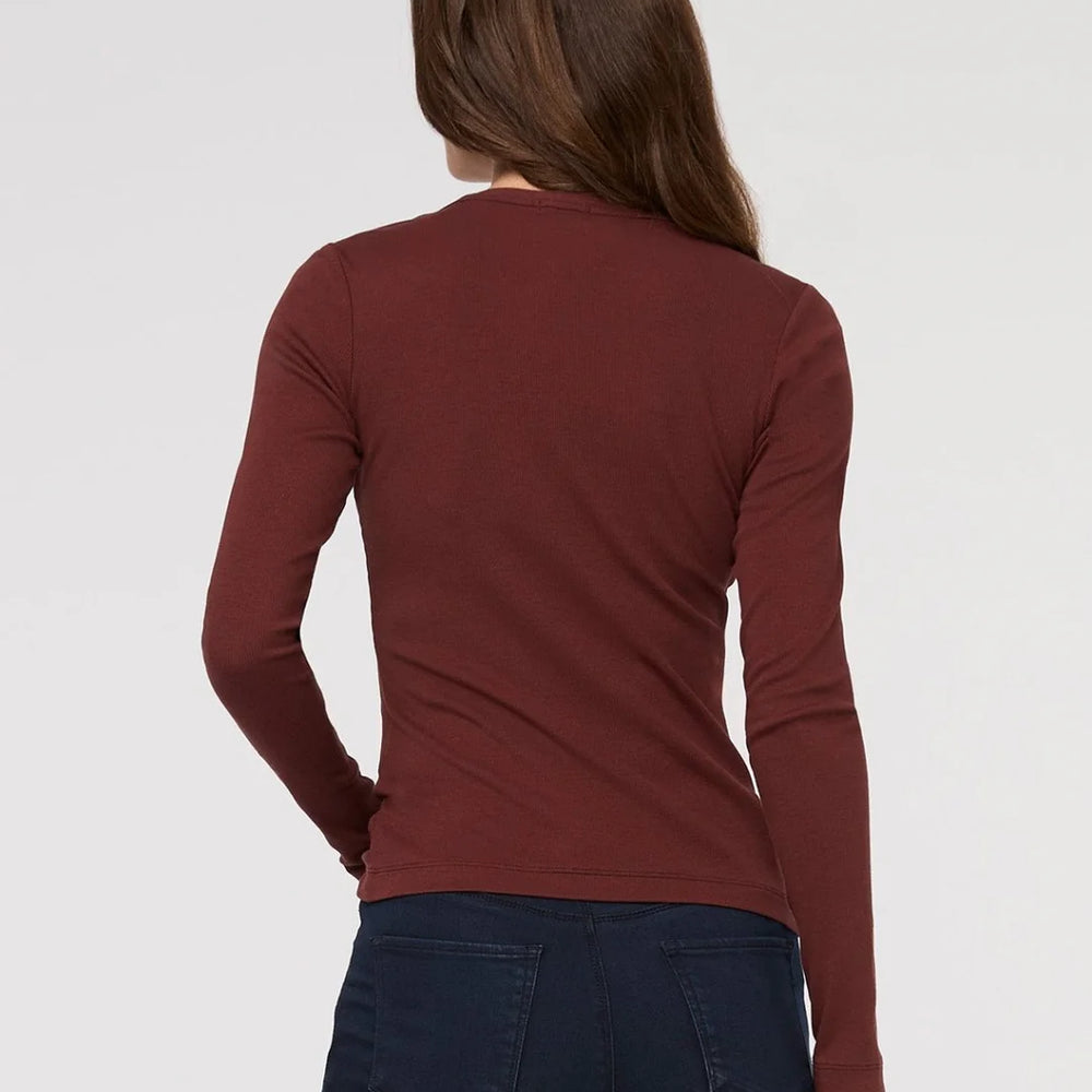 
                      
                        Person wearing a maroon long-sleeve shirt and dark jeans on a white background
                      
                    