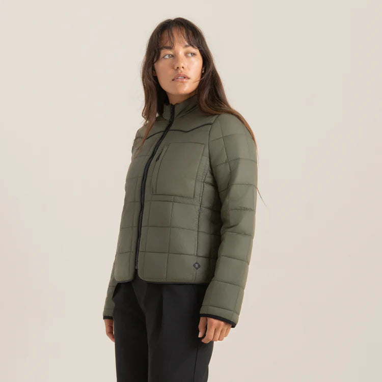 
                      
                        A woman wearing the design detail on the Base Camp Jacket by Roark zipped up 
                      
                    