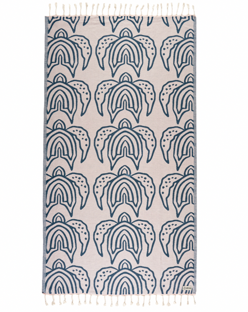 Enjoy your time in the sand with the eco-conscious Sand Cloud Turtle Island Towel, available at Harbour Thread boutique. 