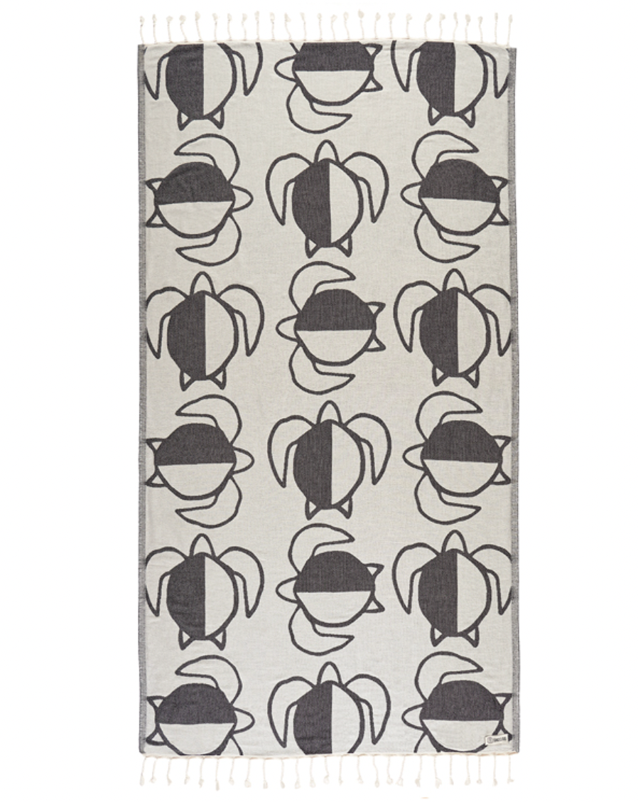 Enjoy your time in the sand with the eco-conscious Sand Cloud Turtle Checkers Towel, available at Harbour Thread boutique. 