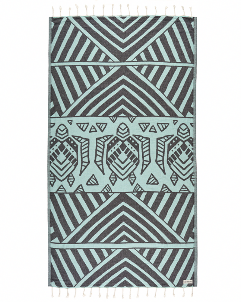 Enjoy your time in the sand with the eco-conscious Sand Cloud Geo Turtle Towel, available at Harbour Thread boutique. 