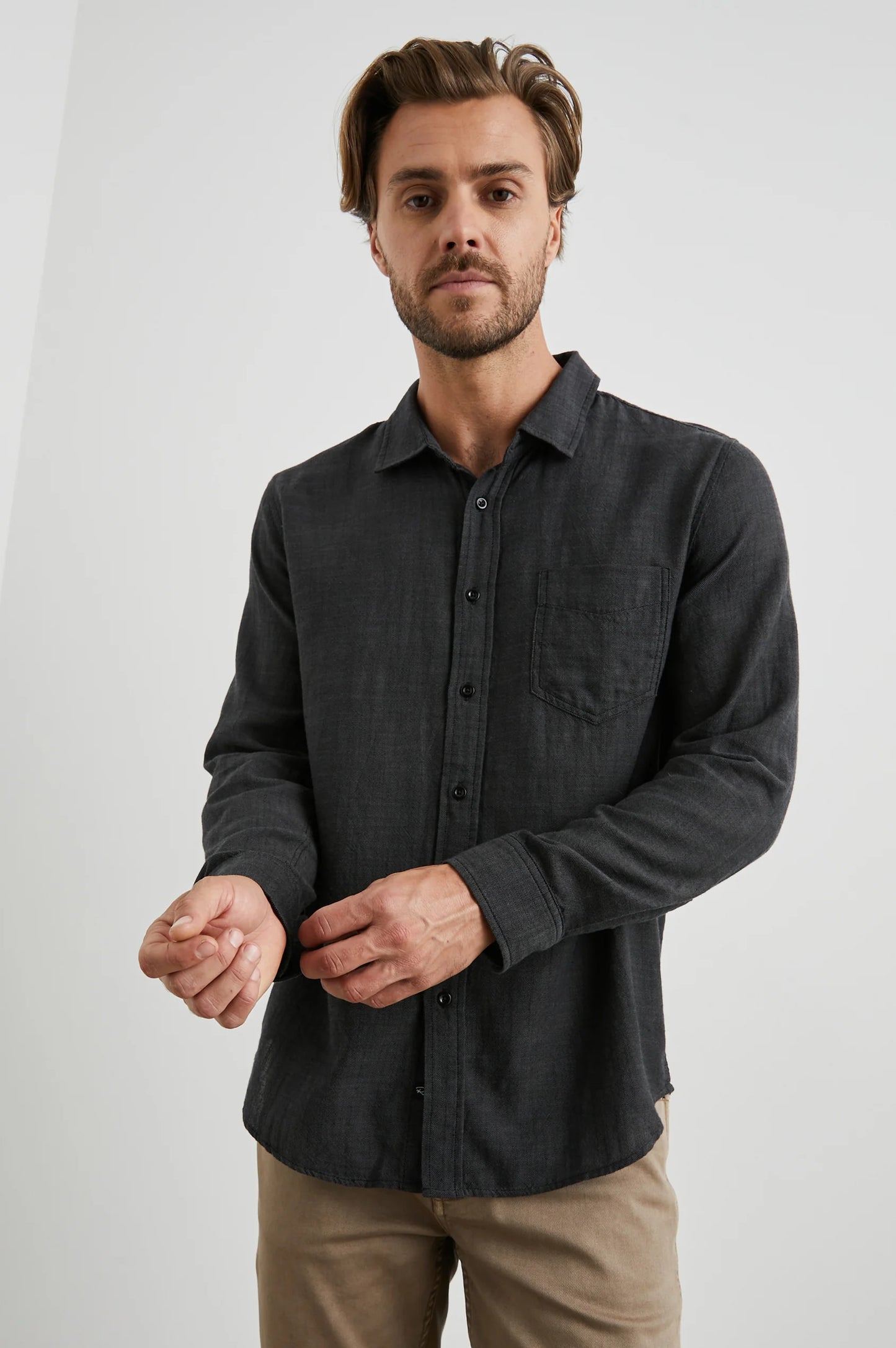 Front view of a man wearing the Black Chambray Long Sleeve Wyatt Shirt by Rail