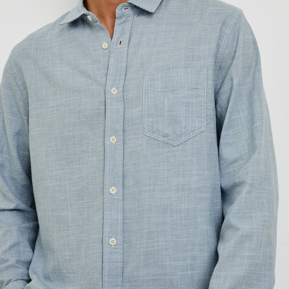 
                      
                        Men's blue cotton button down shirt with patch pocket
                      
                    