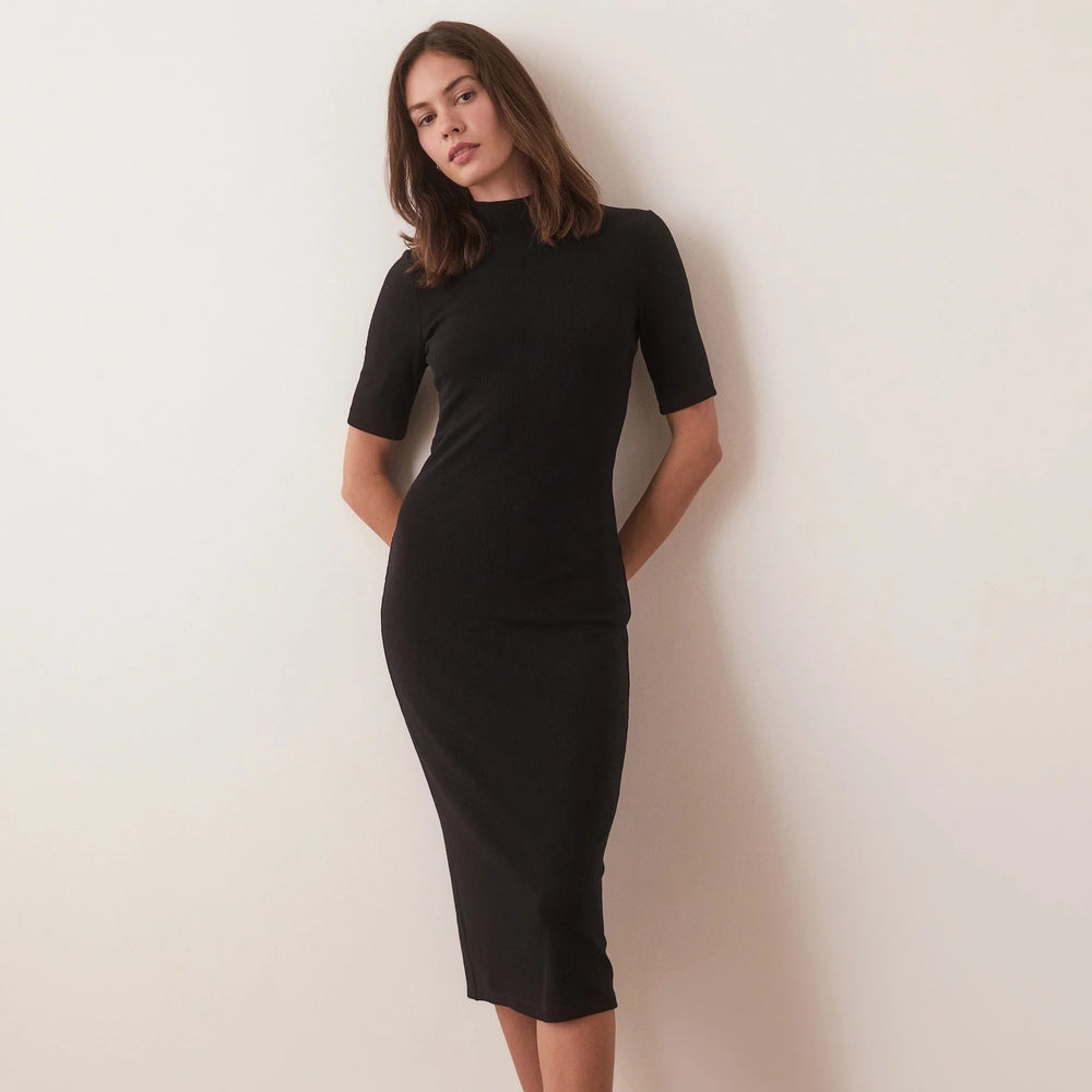 A woman wearing the Lexi Rib Mock Neck Midi Dress by Marine Layer in the color black