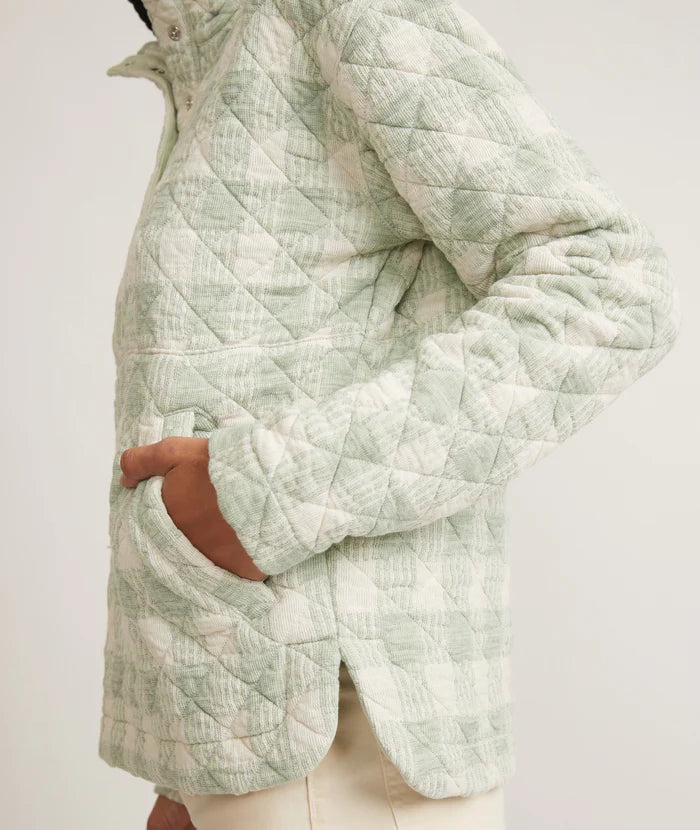Side view of model putting their hands in the pockets of the Iris Quilted Pullover in color mint by Marine Layer