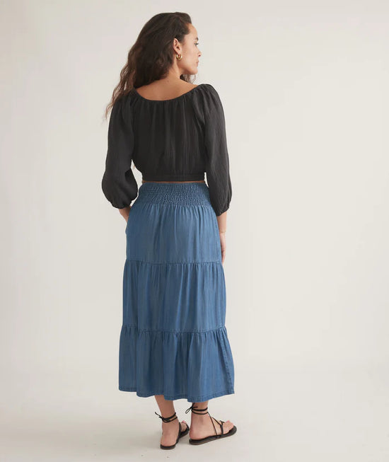 Back view of the Marine Layer Corinne Chambray Maxi Skirt in the color Medium Wash