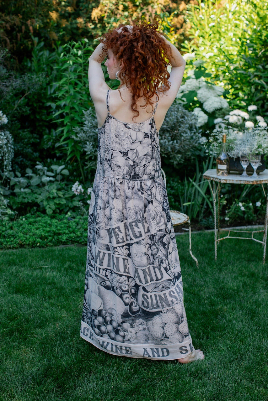 A woman wearing the Market of Stars Peace Wine & Sunshine Bohéme Long Slip Dress.